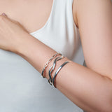 Selection of Sterling Silver Bangles By Urban Pizazz Displayed on Models Arm